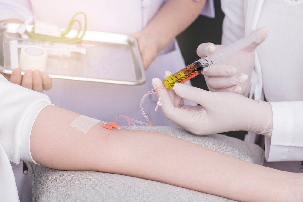 B12 injections for energy being filled by a healthcare provider using a syringe and vial.