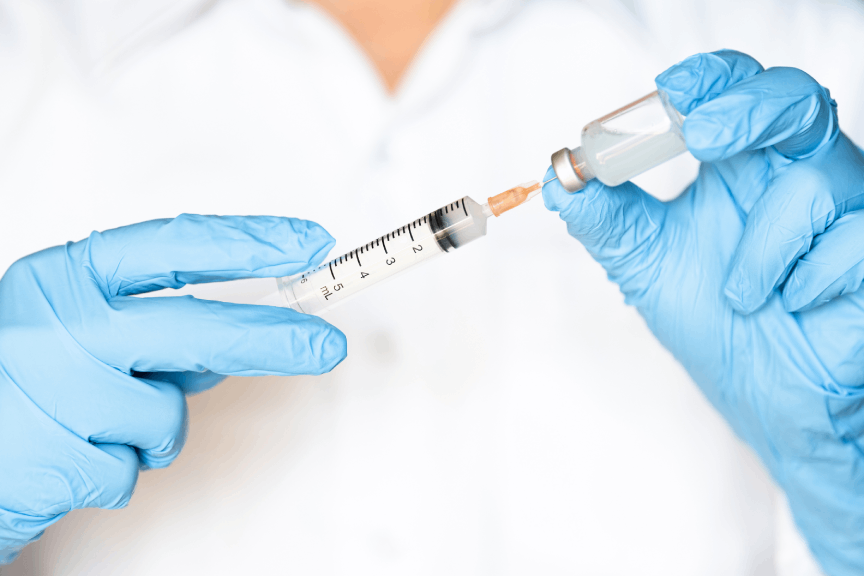 Nurse getting a shot ready to boost your energy, support your immune system, and promote overall health with vitamin injections.