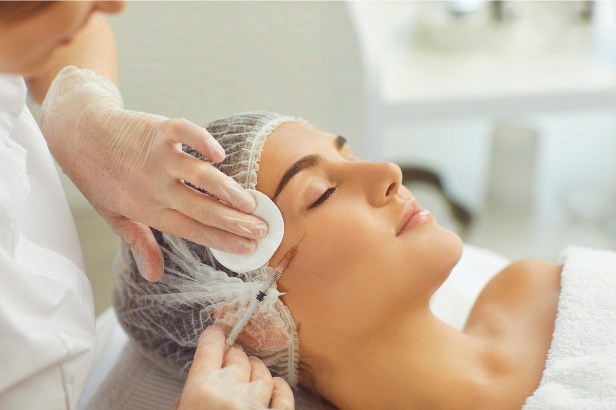 A woman receiving a professional facial treatment, as part of an injectable peptides skin renewal session.