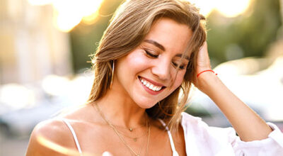 Light therapy for skin shown during a relaxing facial treatment using a glowing handheld device.